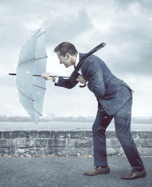 guy holding an umbrella towards a heavy rain